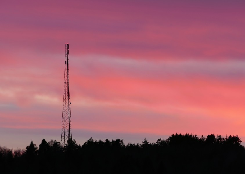 Telecommunications mast in red sunset