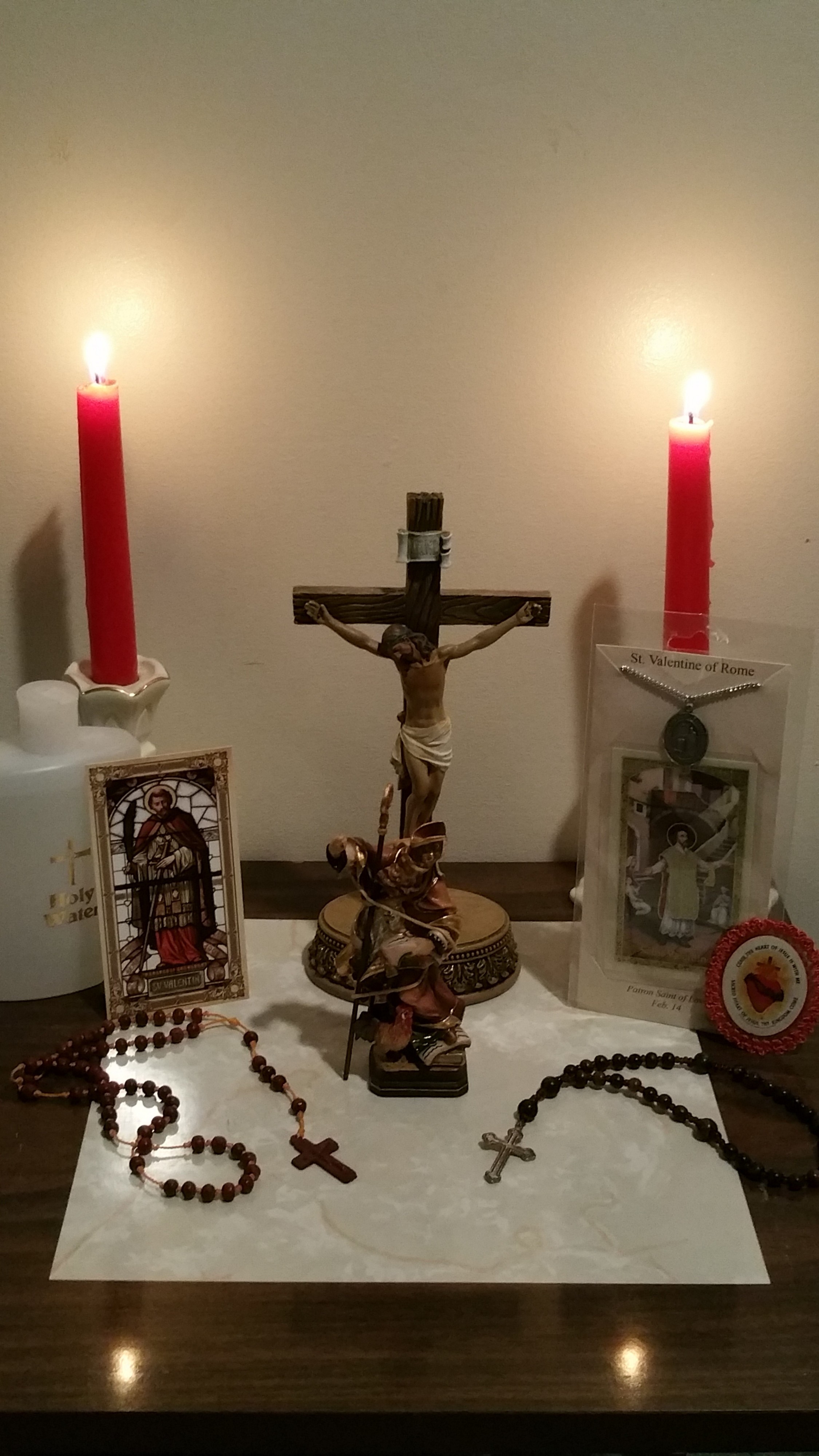Saint Valentine statue, devotional medal, and holy cards