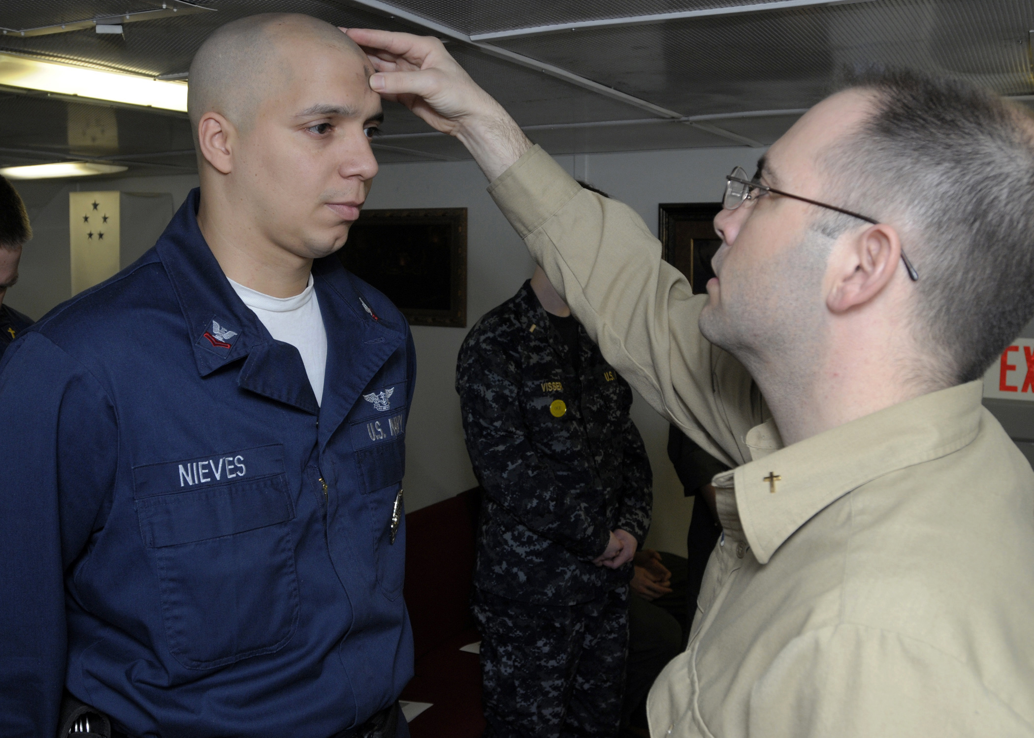 US Navy 090225-N-4014G-008 Air Traffic Controller 2nd class Alejandro Nieves receives the Imposition of Ashes from Navy Chaplain Lt. Chris Stanfield during an Ash Wednesday Mass in the chapel aboard the aircraft carrier USS Dwi