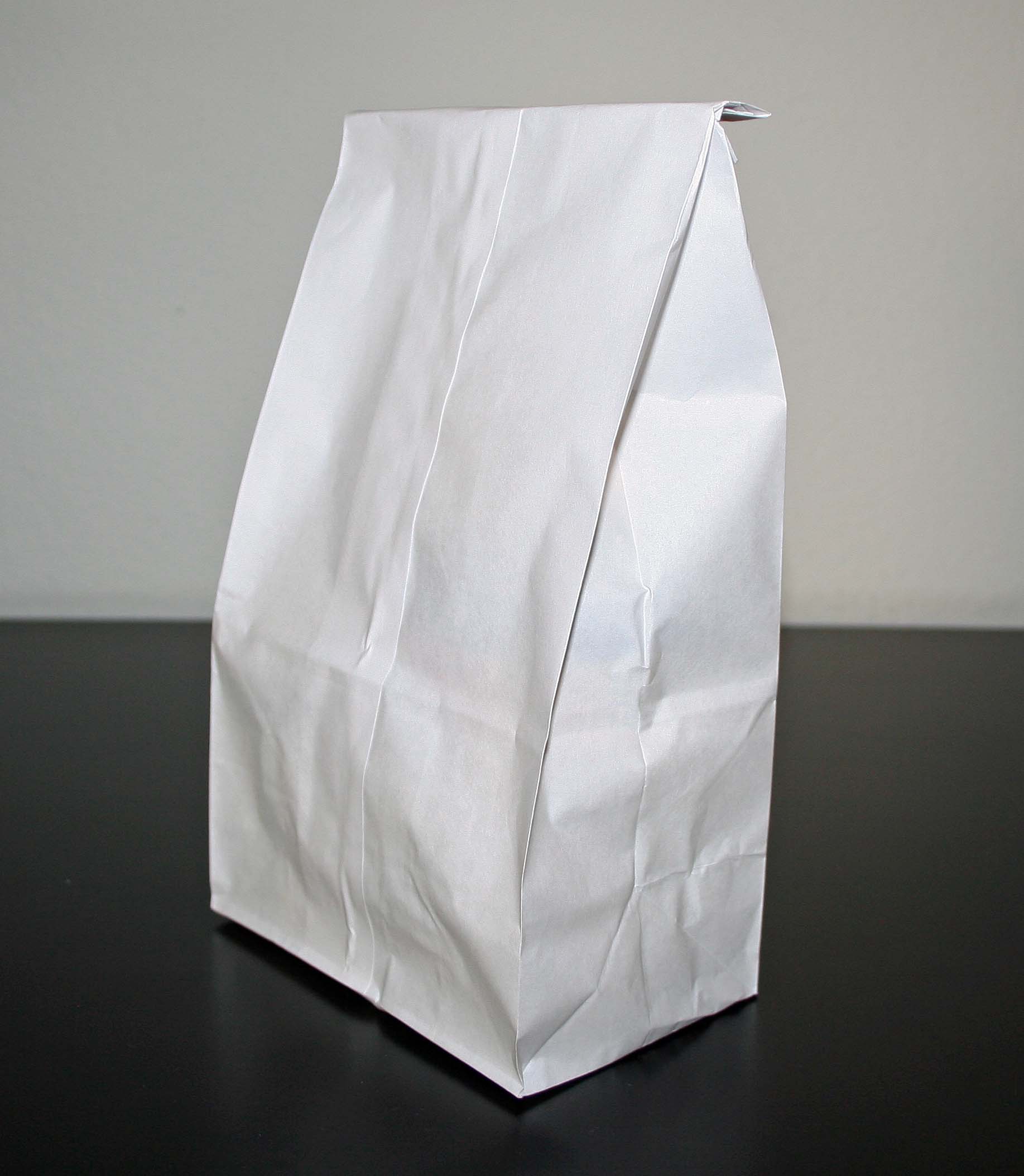 White paper bag on white and black background
