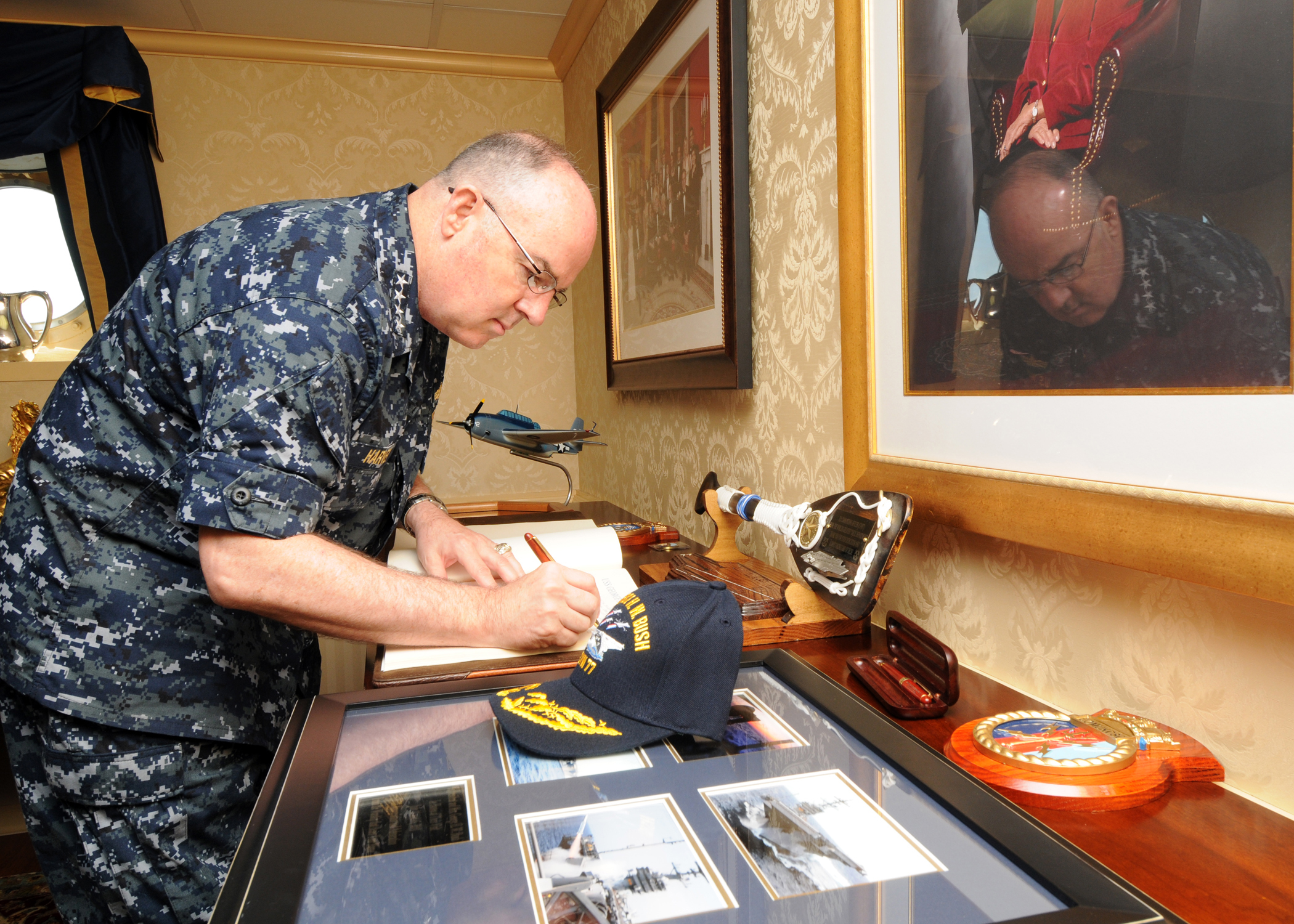 US Navy 100715-N-5658B-069 Adm. J.C. Harvey Jr., commander of U.S. Fleet Forces Command, signs the USS George H.W. Bush (CVN 77) guest book during a visit to the aircraft carrier
