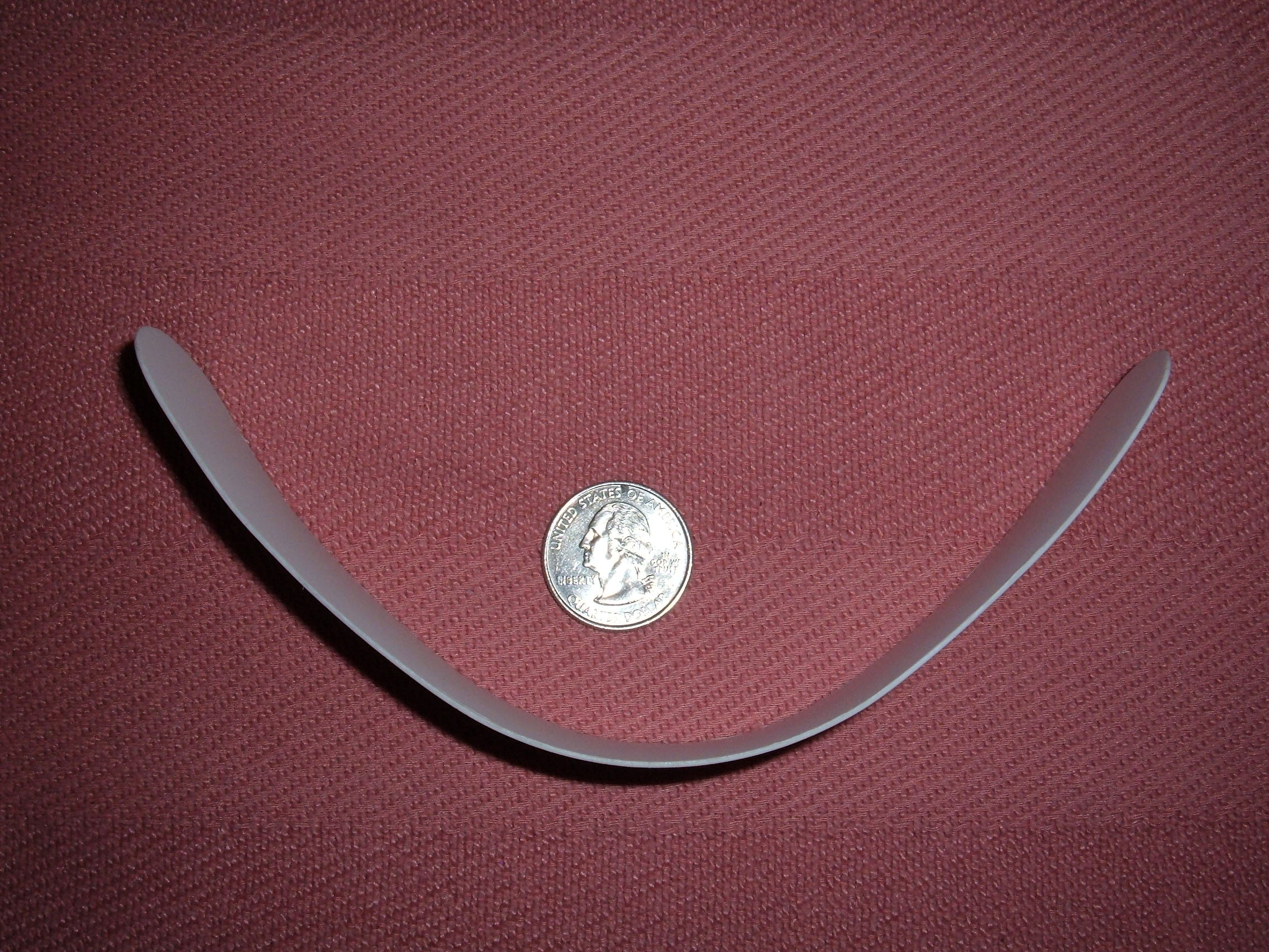 Plastic roman collar compared with US quarter