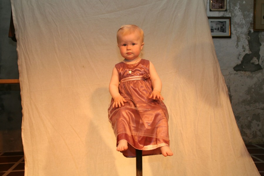 Little girl posing on stool