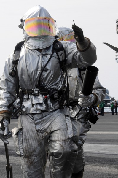US Navy 081022-N-3659B-039 Sailors assigned to the crash and salvage team walk the perimeter of an aircraft