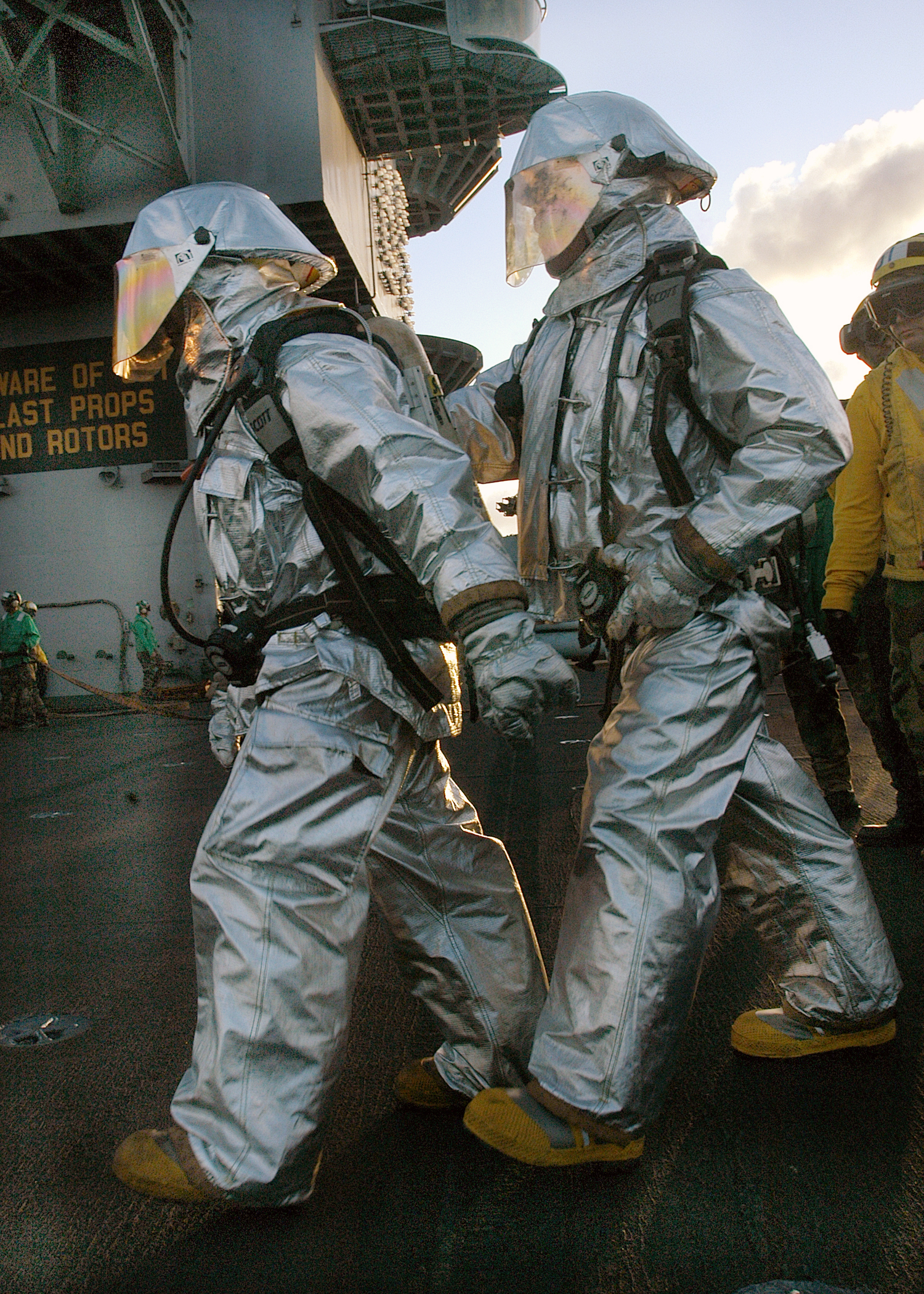 US Navy 040430-N-0119G-003 Sailors assigned to Air Department's Crash and Salvage team prepare to enter the scene of a simulated fire