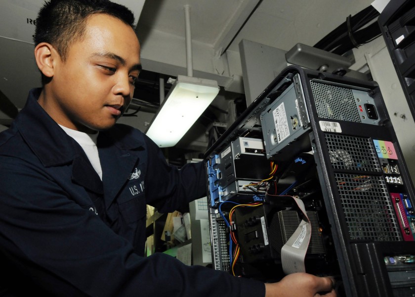 US Navy 090530-N-1062H-127 Information Systems Technician Seaman Michael Cadiz checks the RAM on a computer in the Automatic Data Processing shop