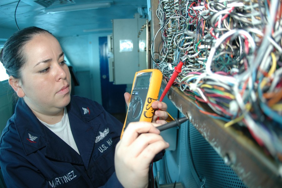 US Navy 091004-N-8960W-014 Interior Communications Electrician 3rd Class Karla Martinez inspects wiring aboard the aircraft carrier USS Nimitz (CVN 68)