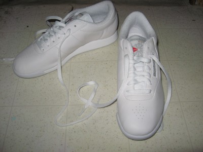 A pair of white Reebok Princess sneakers.