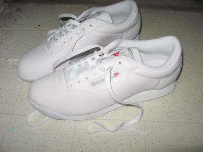 A pair of white Reebok Princess sneakers.