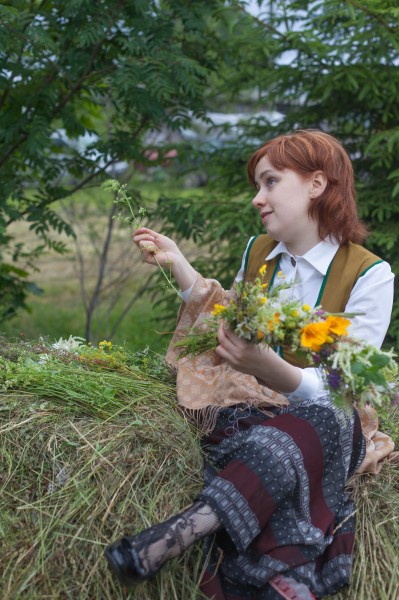 Ieva creating a crown from flowers, Midsummer festival, Latvia