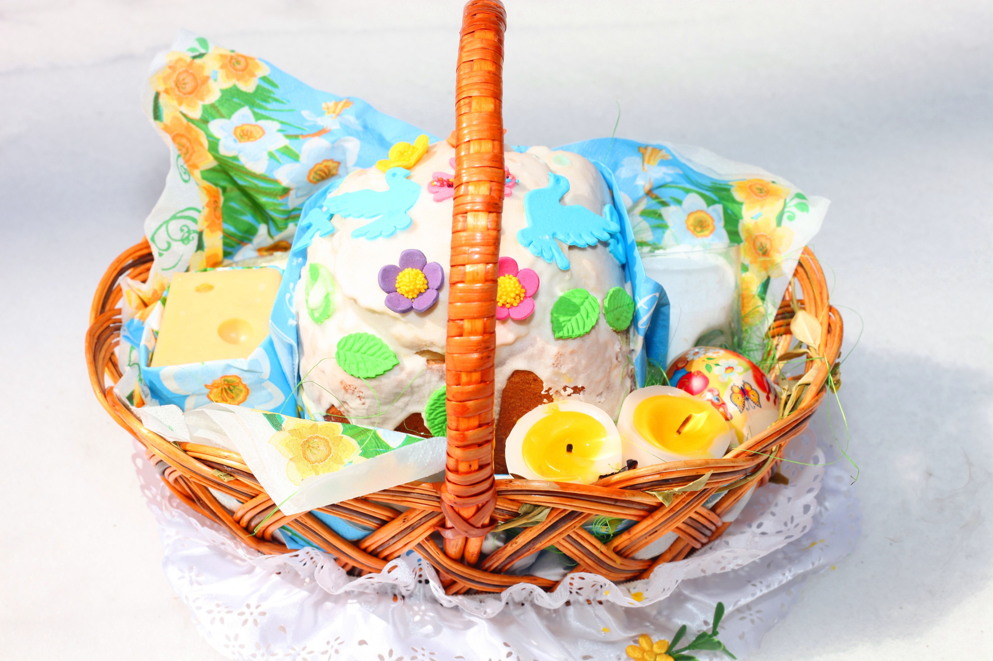 an Easter basket with foods and candles