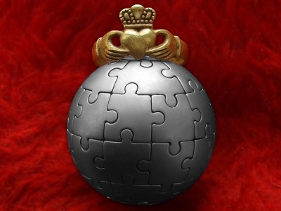 Brass Claddagh ring at spherical puzzle-keychain.