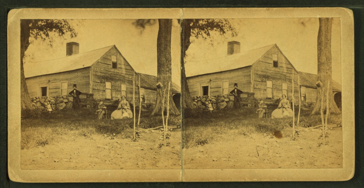 Family members posing against their block house with a stone fence, from Robert N. Dennis collection of stereoscopic views
