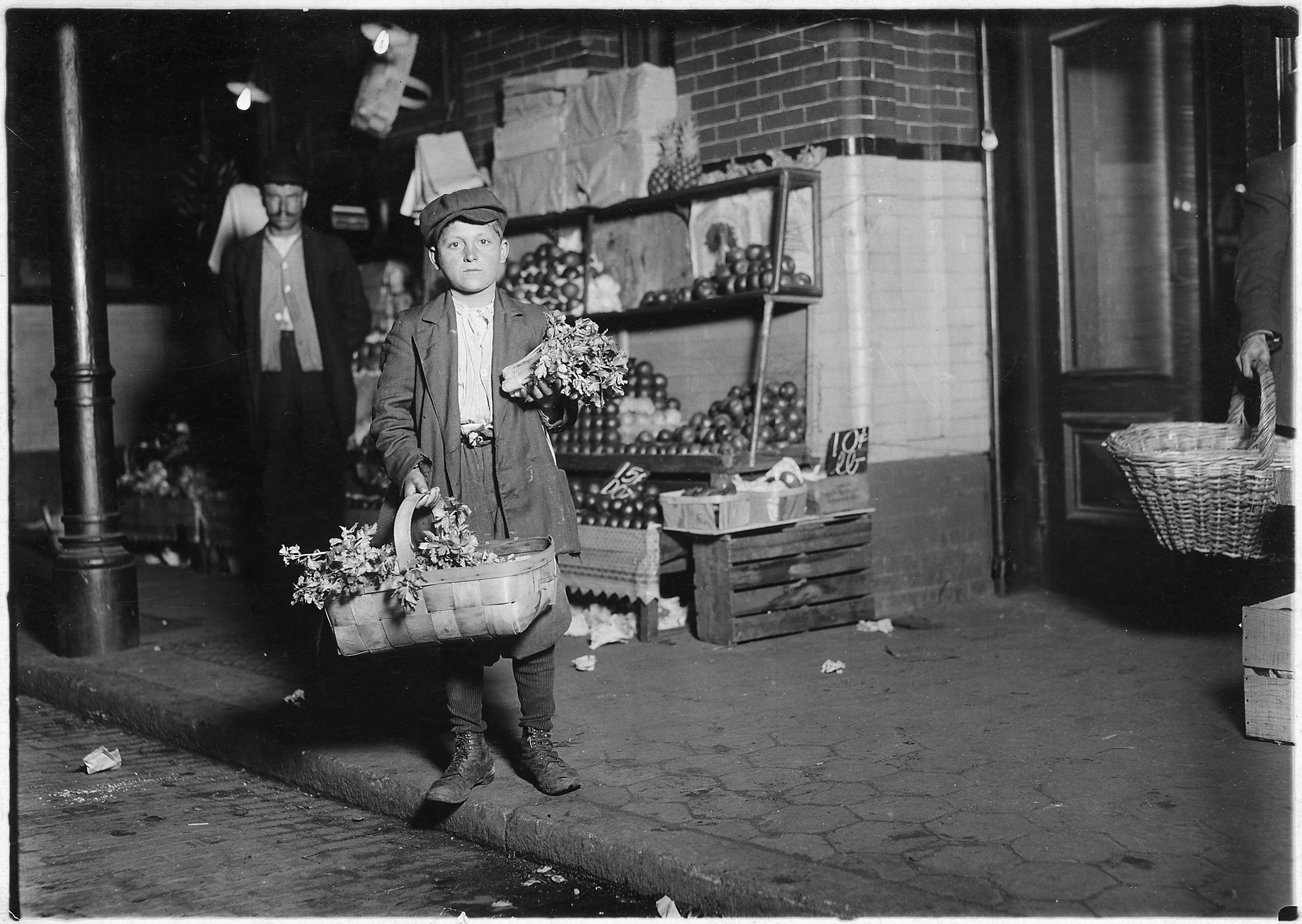 At center market. 11 year old celery vender. He sold until 11 P.M. and was out again Sunday morning selling papers... - NARA - 523535