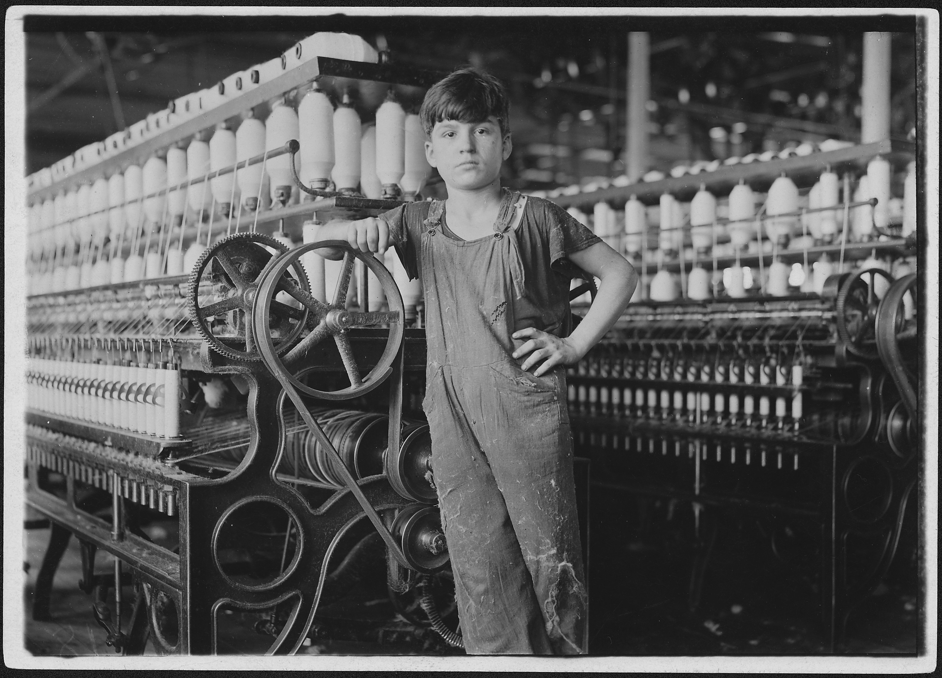 At machine is Stanislaus Beauvais, has worked in spinning room for two years. Salem, Mass. - NARA - 523485