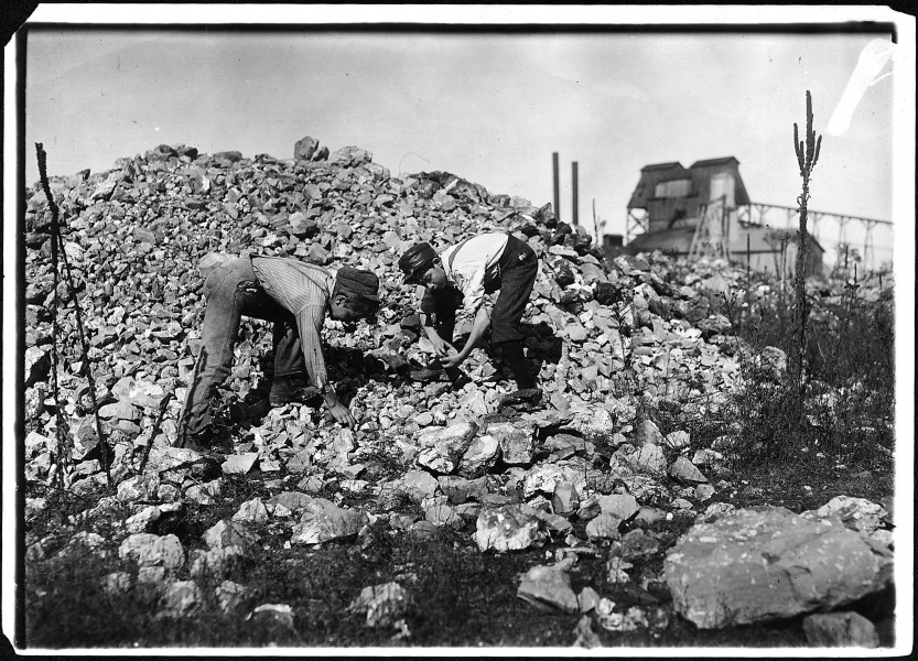 No caption. Two young boys collecting rocks. - NARA - 523333