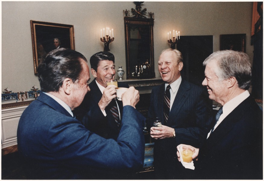 Photograph of the Four Presidents (Reagan, Carter, Ford, Nixon) toasting in the Blue Room prior to leaving for Egypt... - NARA - 198522