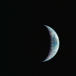 One-third of the Earth's sphere illuminated, Earth's terminator, sunglint, a portion of east Africa, as photographed from the Apollo 11 spacecraft during its first lunar landing mission. While astronauts Neil A. Armstrong, commander, and Edwin E. Aldrin Jr., lunar module pilot, descended in the Lunar Module (LM) 