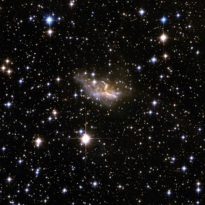 ESO 99-4 is a galaxy with a highly peculiar shape that is probably the remnant of an earlier merger process that has deformed it beyond visual recognition, leaving the main body largely obscured by dark bands of dust. ESO 99-4 lies in a rich field of foreground stars, in the constellation of Triangulum Australe, the Southern Triangle, about 400 million light-years away.