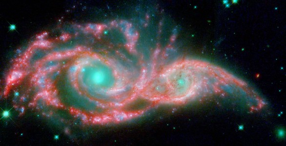 These shape-shifting galaxies have taken on the form of a giant mask. The icy blue eyes are actually the cores of two merging galaxies, called NGC 2207 and IC 2163, and the mask is their spiral arms. The false-color image consists of infrared data from NASA's Spitzer Space Telescope (red) and visible data from NASA's Hubble Space Telescope (blue/green).
NGC 2207 and IC 2163 met and began a sort of gravitational tango about 40 million years ago. The two galaxies are tugging at each other, stimulating new stars to form. Eventually, this cosmic ball will come to an end, when the galaxies meld into one. The dancing duo is located 140 million light-years away in the Canis Major constellation.