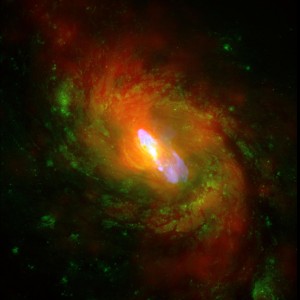 This is a composite image of NGC 1068, one of the nearest and brightest galaxies containing a rapidly growing super-massive black hole. The X-ray images and spectra obtained using Chandra's High Energy Transmission Grating Spectrometer show that a strong wind is being driven away from the centre of NGC 1068 at a rate of about a million miles per hour. This wind is likely generated as surrounding gas is accelerated and heated as it swirls toward the black hole. A portion of the gas is pulled into the black hole, but some of it is blown away. High energy X-rays produced by the gas near the black hole heat the ouflowing gas, causing it to glow at lower X-ray energies. X-ray data from the Chandra X-ray Observatory are shown in red, optical data from the Hubble Space Telescope in green and radio data from the Very Large Array in blue. The spiral structure of NGC 1068 is shown by the X-ray and optical data, and a jet powered by the central super-massive black hole is shown by the radio data.