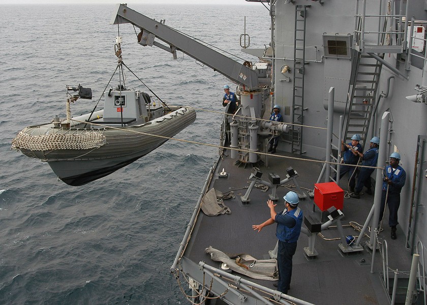 US Navy 040420-N-6433N-082 Crewmembers assigned to the Deck Department lower a Rigid Hull Inflatable Boat (RHIB) during a man overboard drill