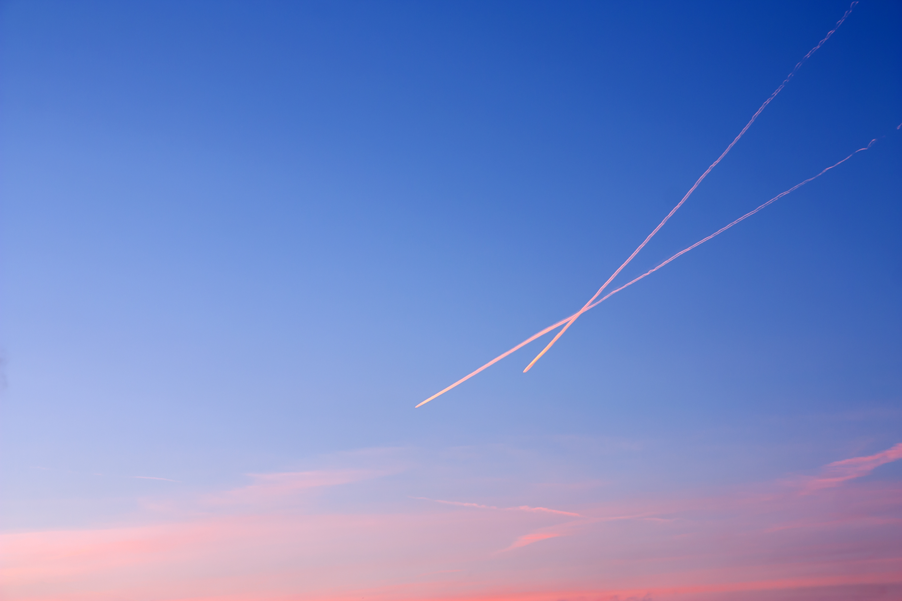 Contrails in the sky at sunset
