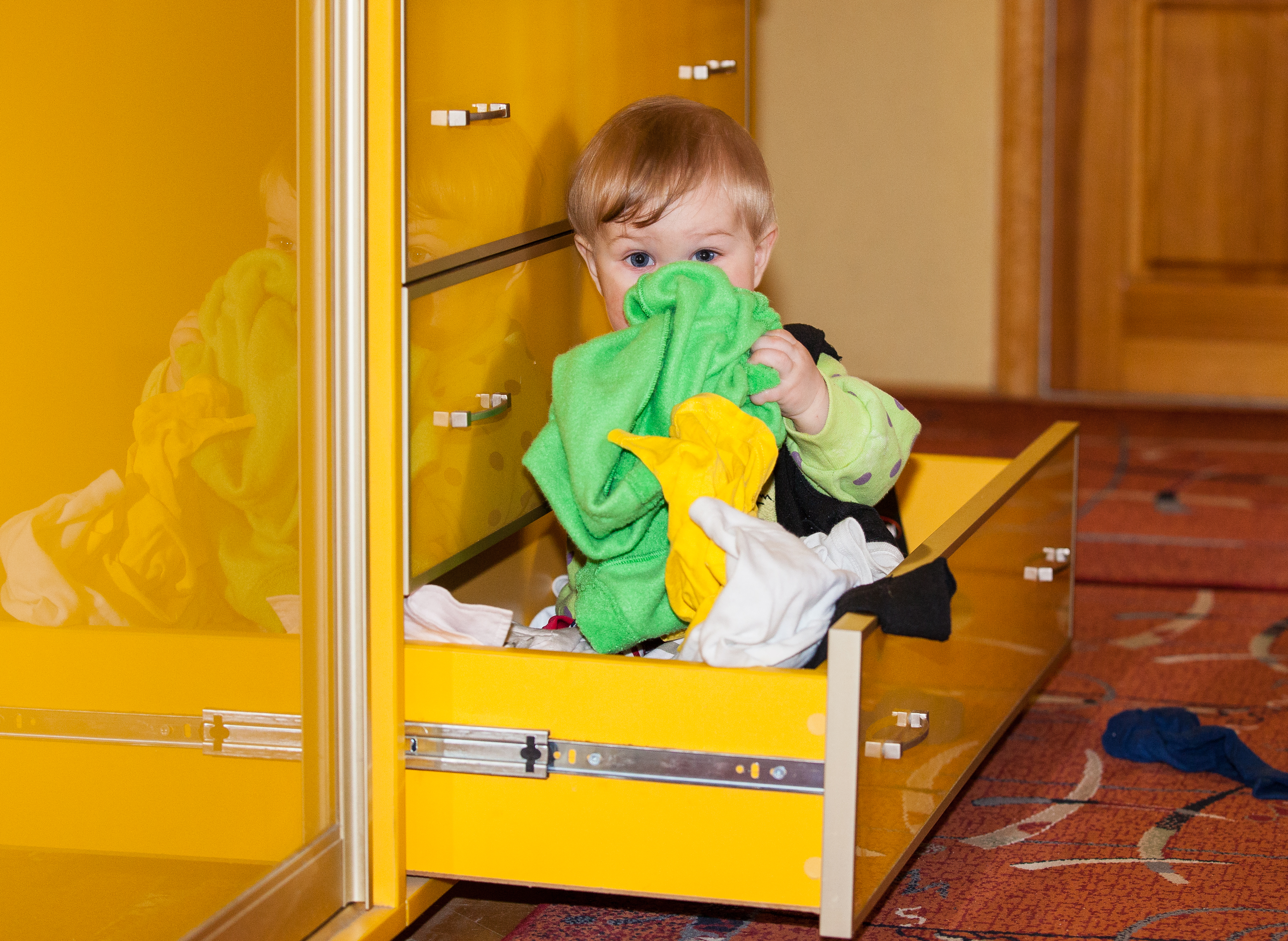 a 10-month-old boy playing in a drawer in April 2014