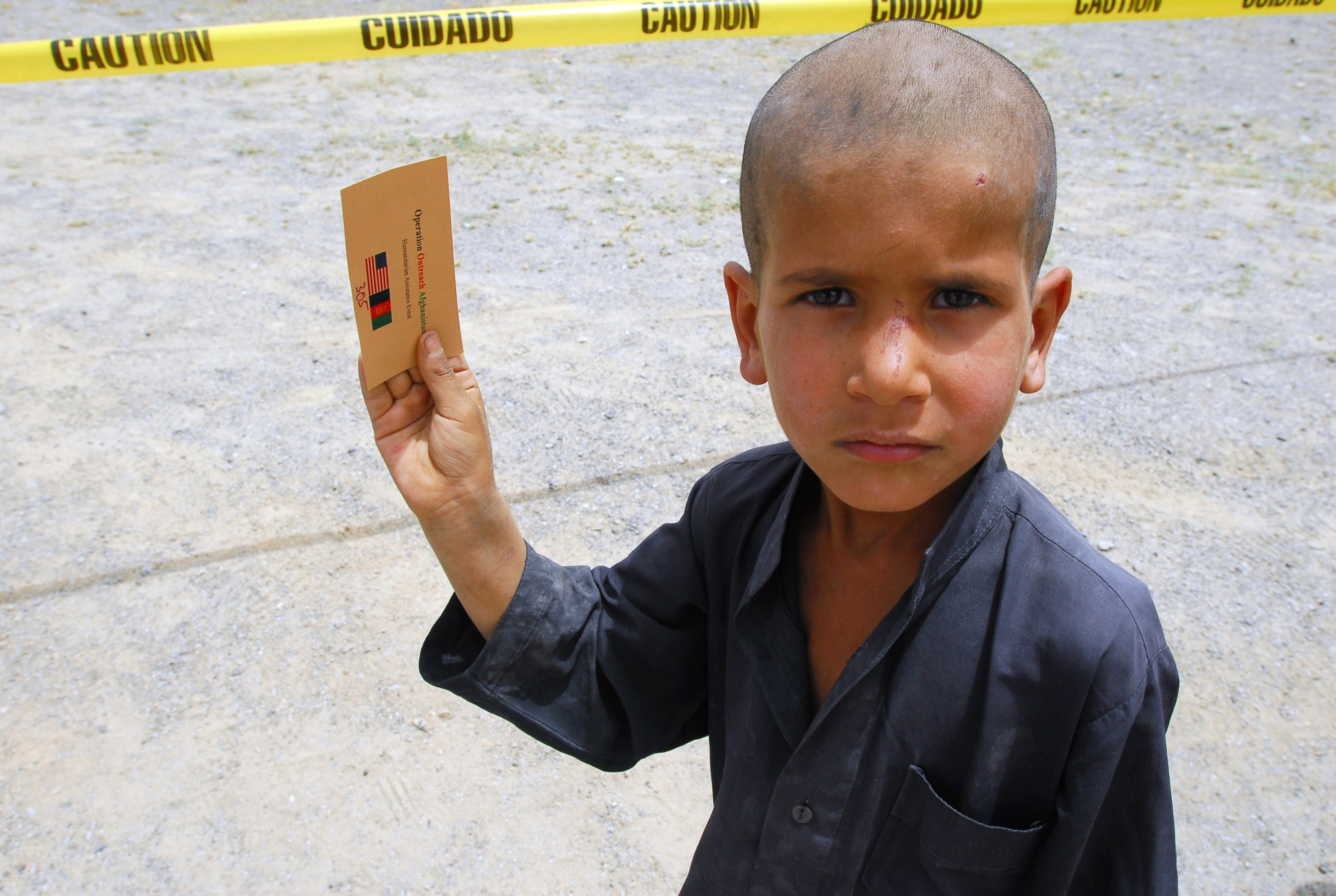 Afghan Boy Holds Up Ticket for Humanitarian Aid Drop With South Carolina Guardsmen DVIDS300691