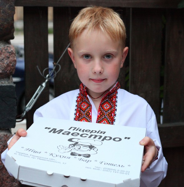 A boy with a box of pizza