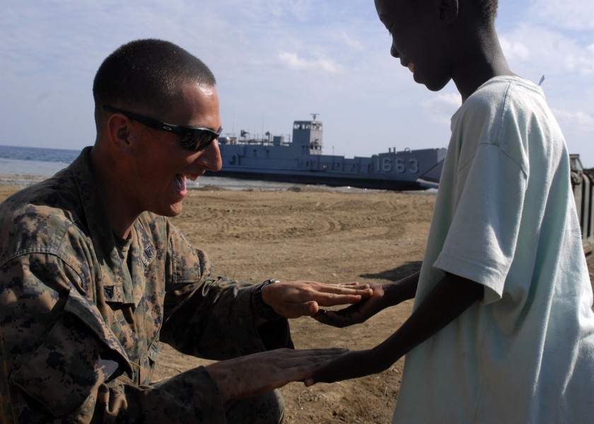 US Navy 100213-N-2000D-108 A Marine plays with a Haitian child