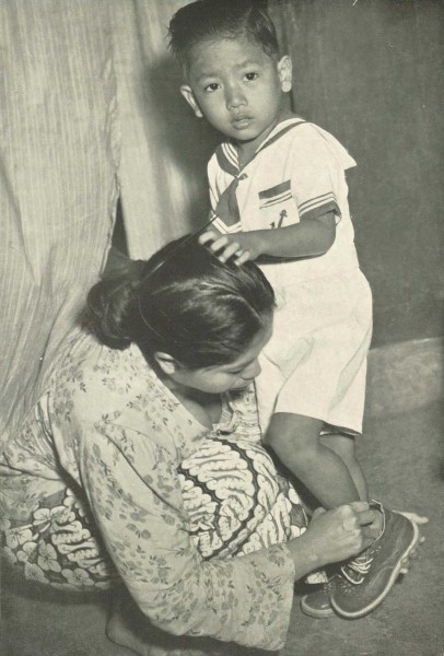 Woman dressing her son for the first day of school, Wanita di Indonesia p43 (Ministry of Information)