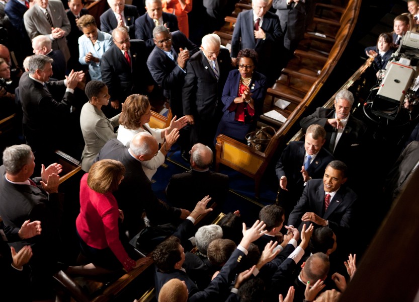 Barack Obama shakes hands as he enters the House Chamber at the U.S. Capitol in Washington, D.C., 2009
