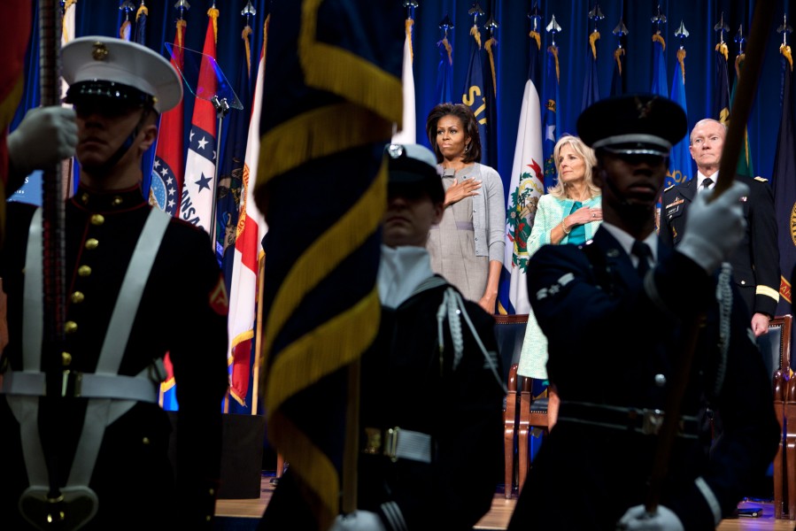 Michelle Obama, Dr. Jill Biden, and Gen. Martin Dempsey stand for the national anthem, 2012