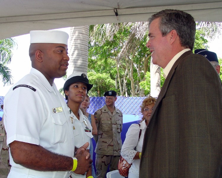 US Navy 040712-N-0351R-001 Aviation Ordnanceman 2nd Class Robert D. Flake from Fort Smith, Ark., and Interior Communications 2nd Class Tanya Santiago from Lakehurst, N.J., met with Florida Governor Jeb Bush, 