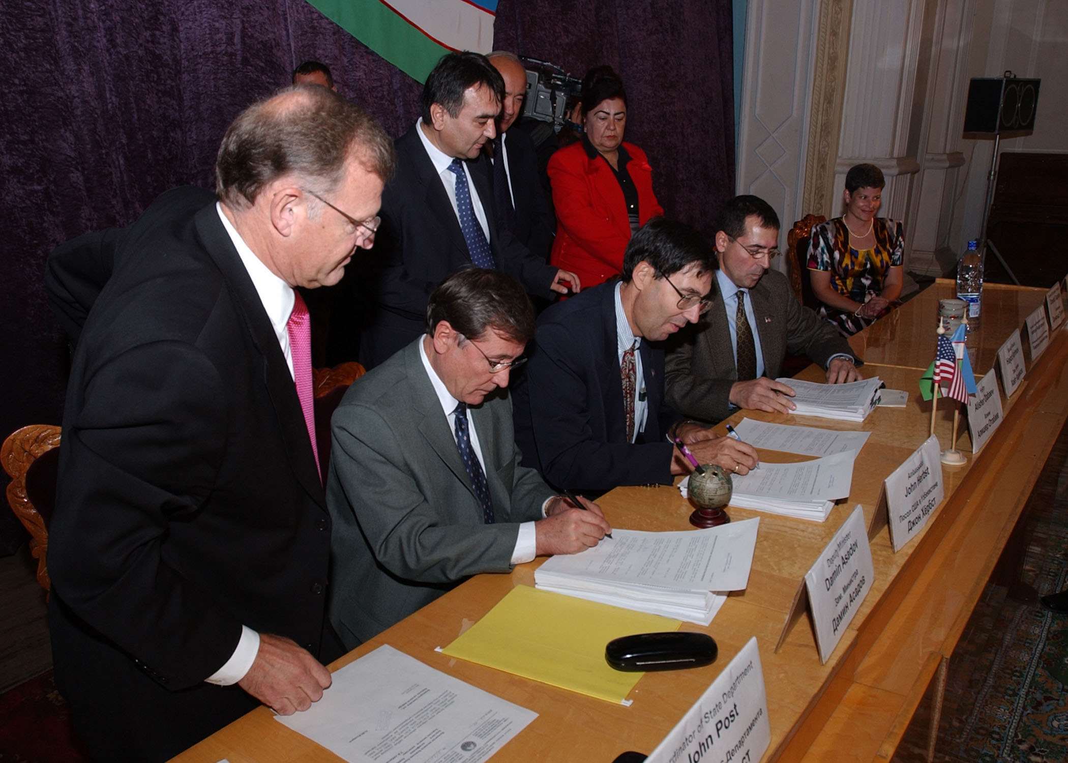 US Navy 021024-N-5329L-001 John Herbst, U.S. Ambassador to Uzbekistan, and Hakim Alisher A. Atabaev, Mayor of the Fergana region, sign the official turnover documents between the republic of Uzbekistan and the United States