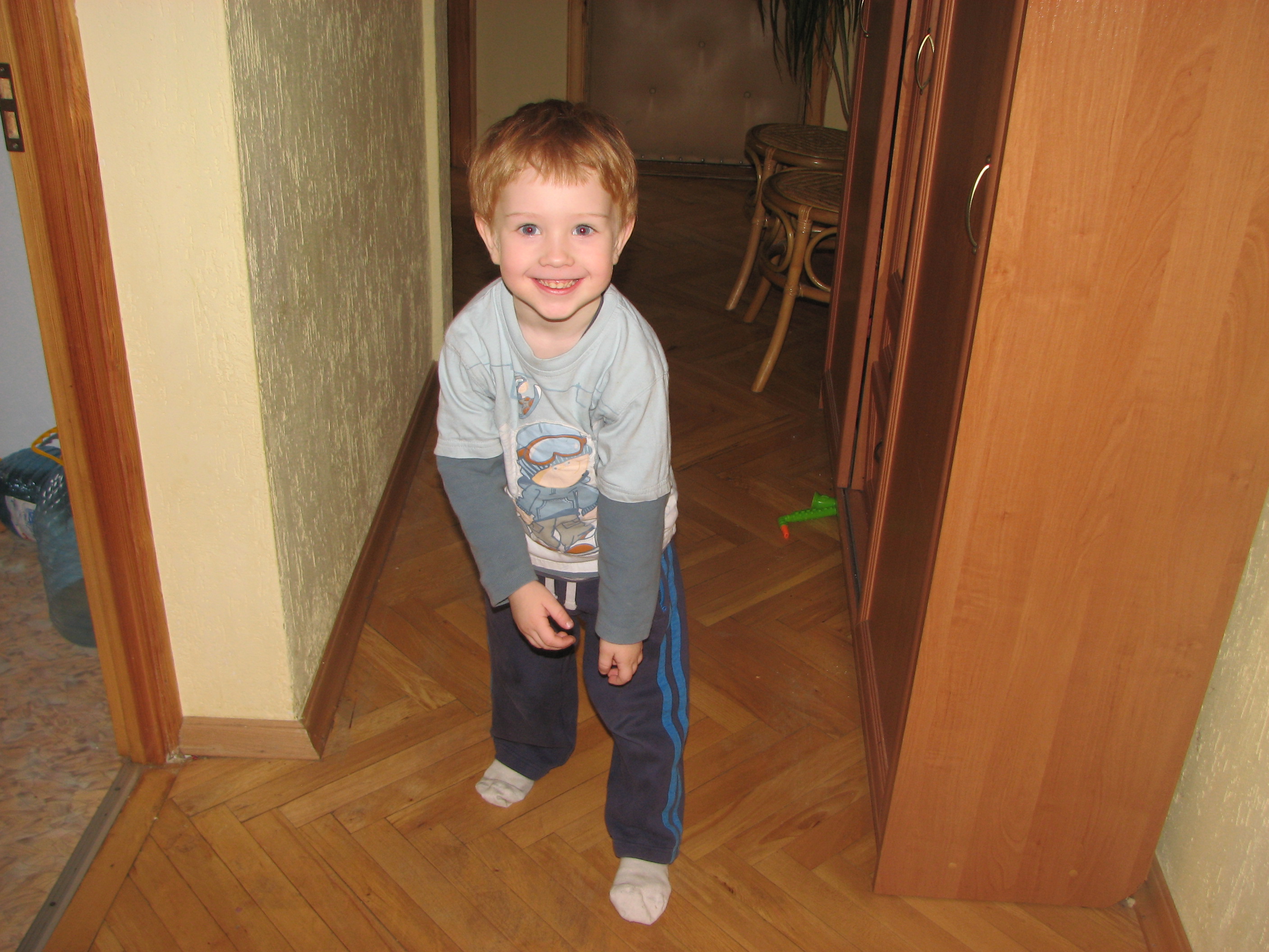 A small boy in an apartment corridor