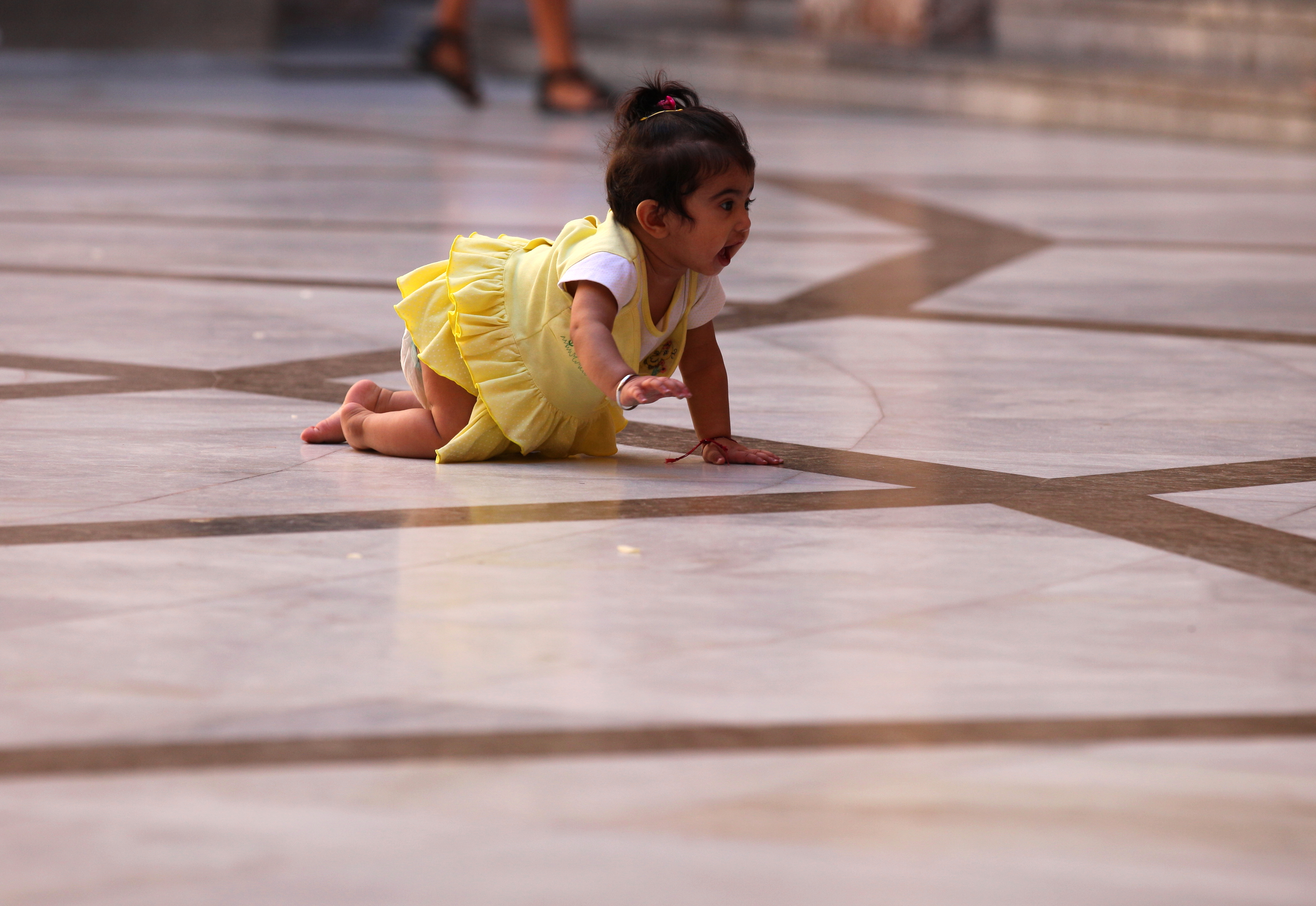 a baby girl crawling in Montserrat sanctuary, Catalonia, Spain, August 2013, photo 2