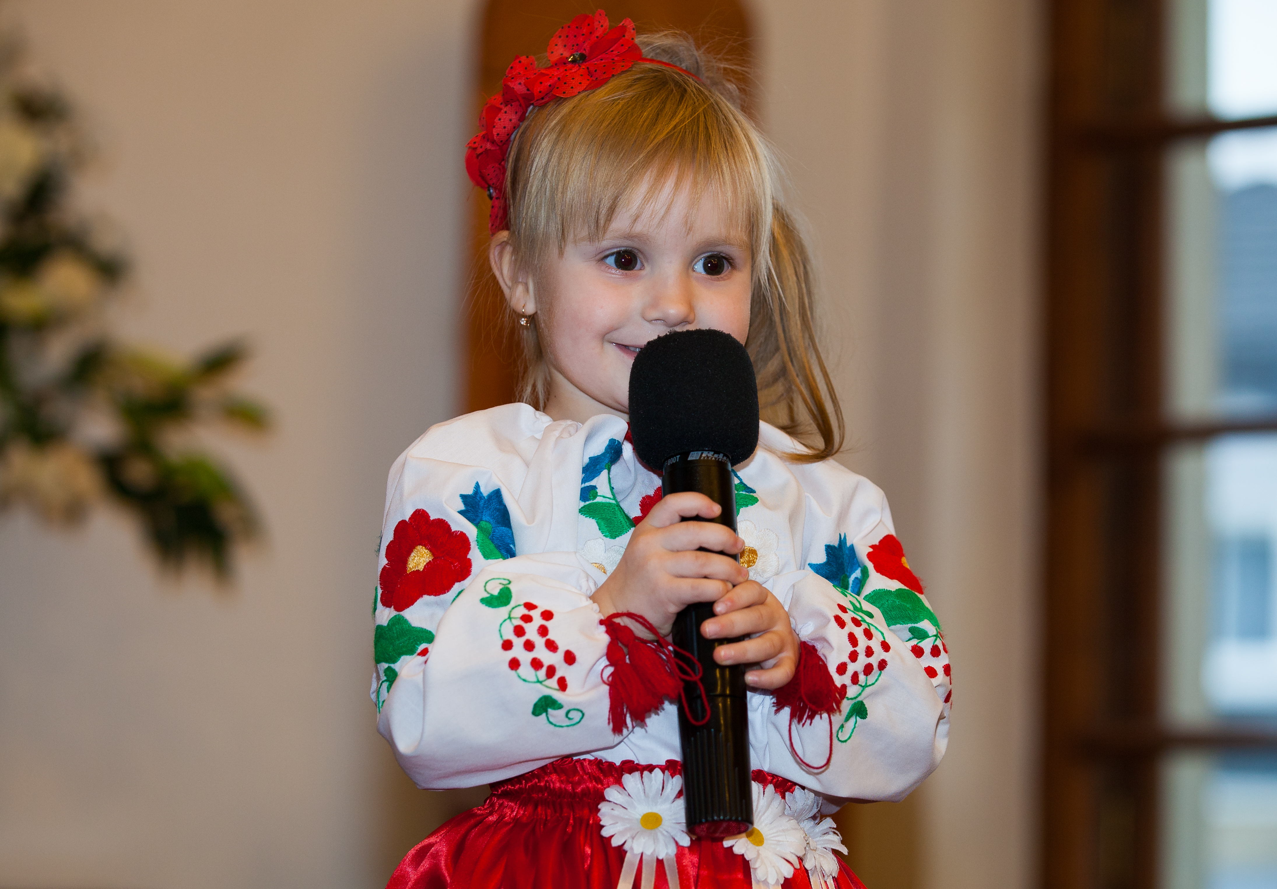 a cute blond child girl with a microphone in a Catholic kindergarten photographed in November 2013, picture 4