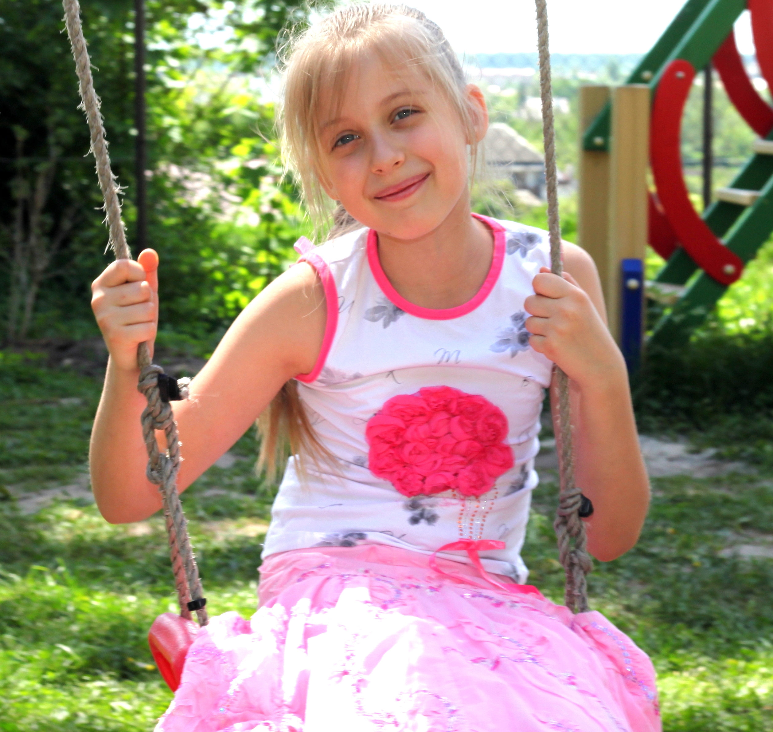 a pretty young blond Catholic girl on a swing photographed in May 2013, picture 3