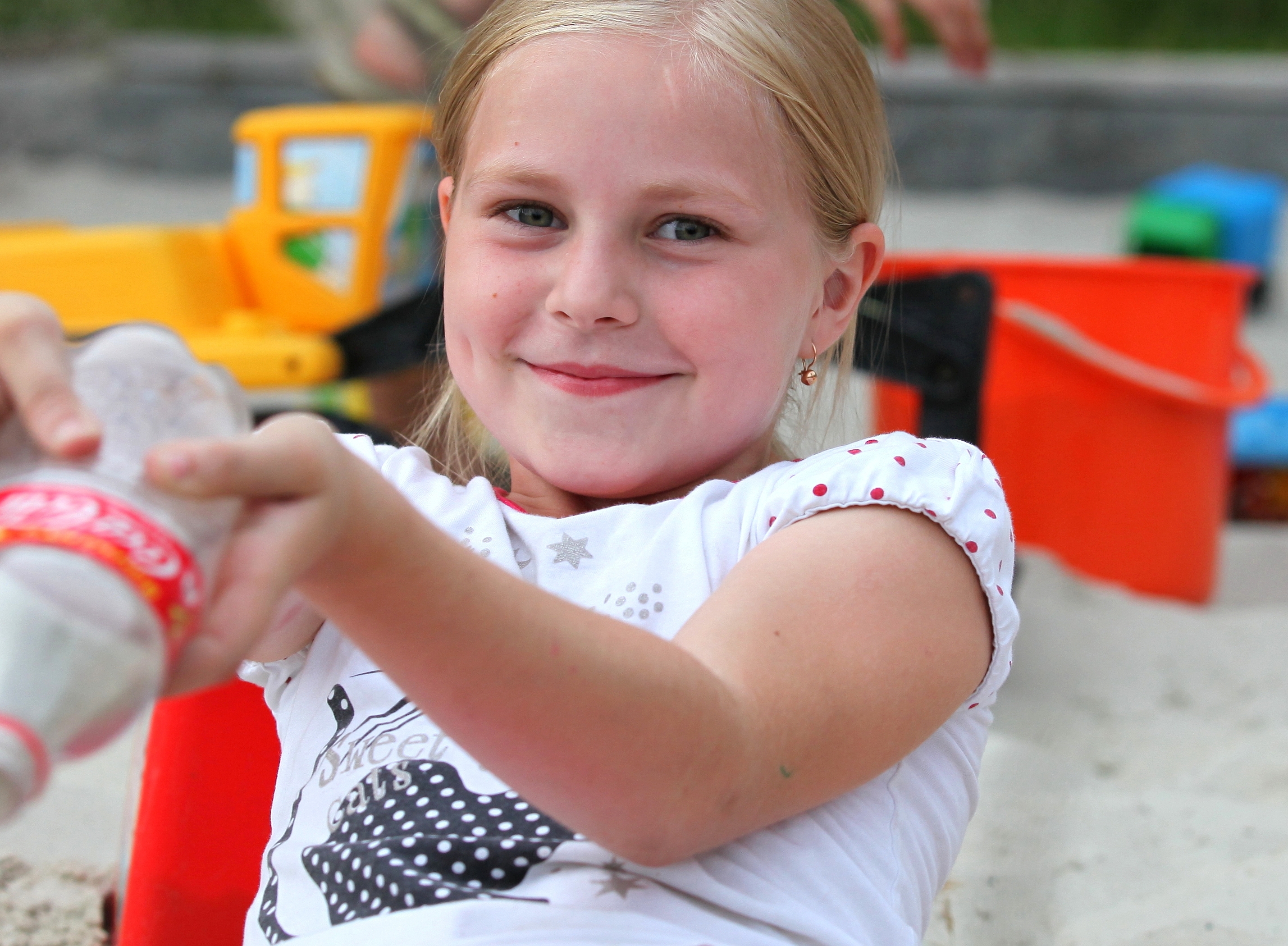 a sweet blond Catholic child girl at a playground in a Christian camp, portrait 2/6