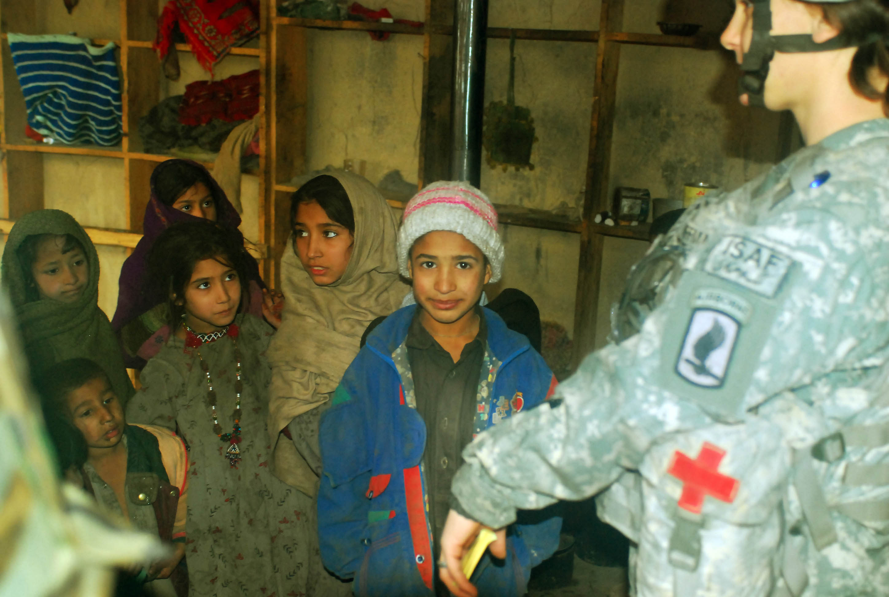 Afghan children line up to be seen by Army medic at Forward Operating Base Naray