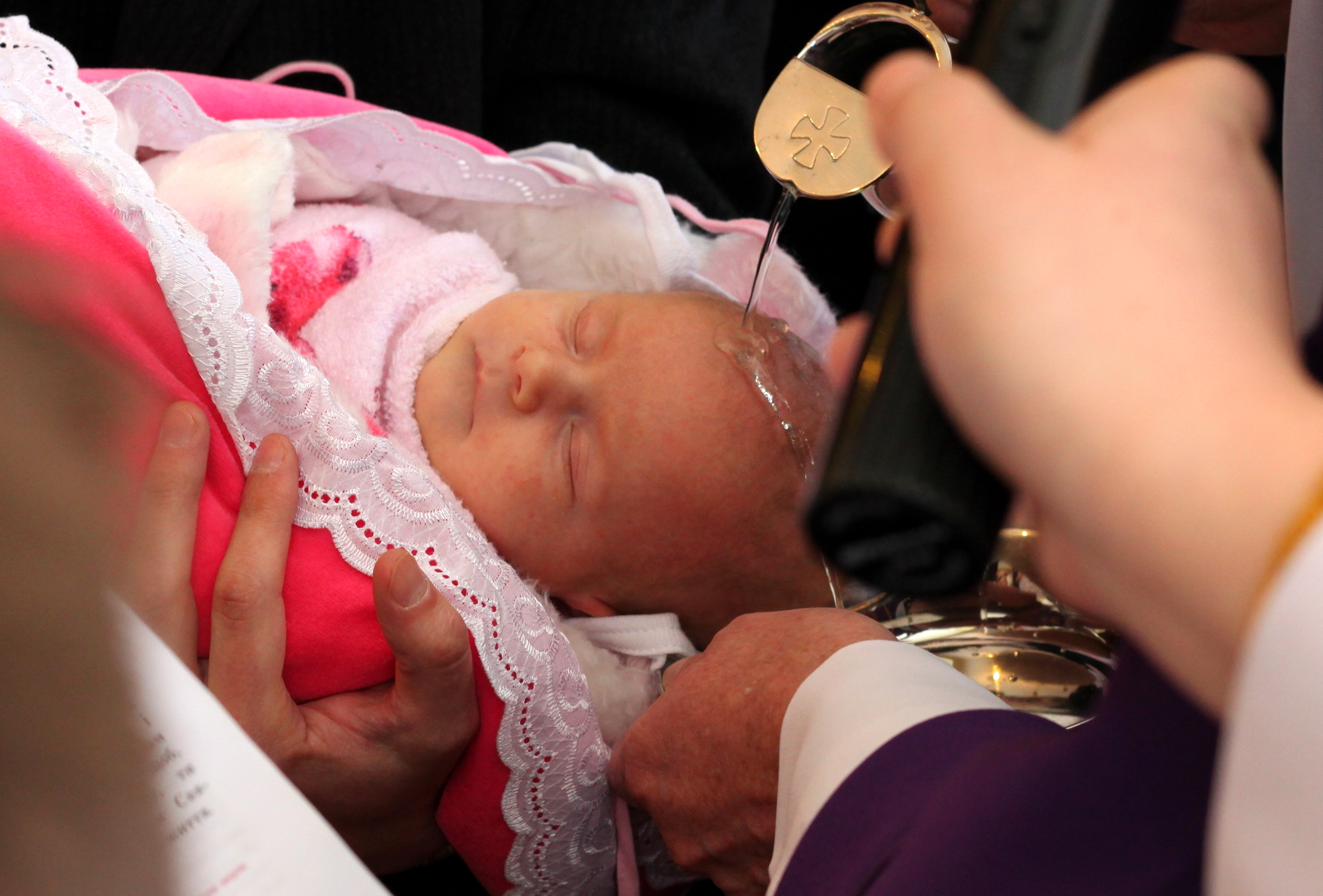 baptism of a baby girl in a Catholic church, picture 5