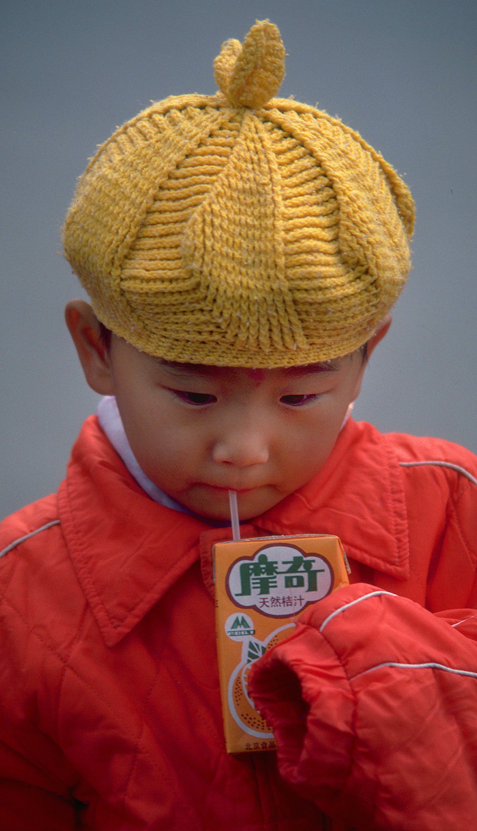 Chinese child drinking from juicebox