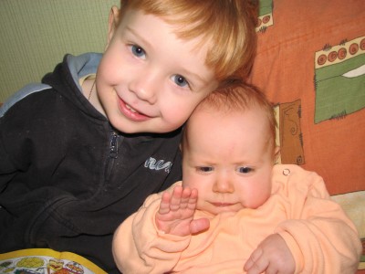 A boy with a funny baby girl (brother and sister)