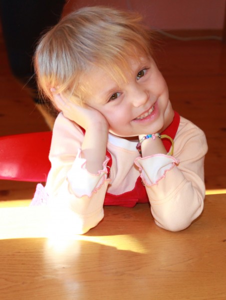 a portrait of a cute blond smiling charming Catholic child girl, photo 3
