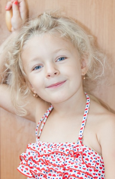 a cute blond child girl photographed in August 2014, picture 1