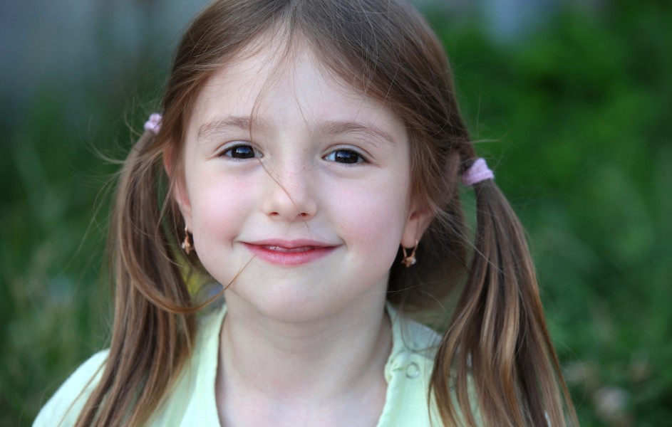 a really cute smiling brunette child girl in a Catholic camp in July 2013, portrait 7/7