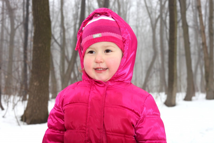a cute Catholic child girl in a foggy forest, photo 1