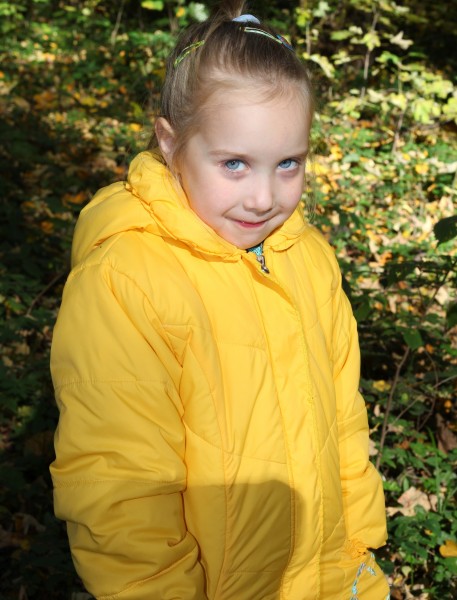 a cute blond Catholic child girl in a forest, picture 2
